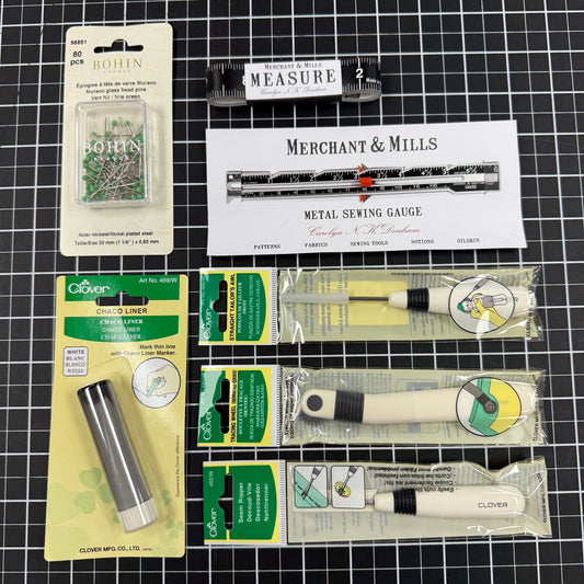 Collection of metal detector accessories on a grid background