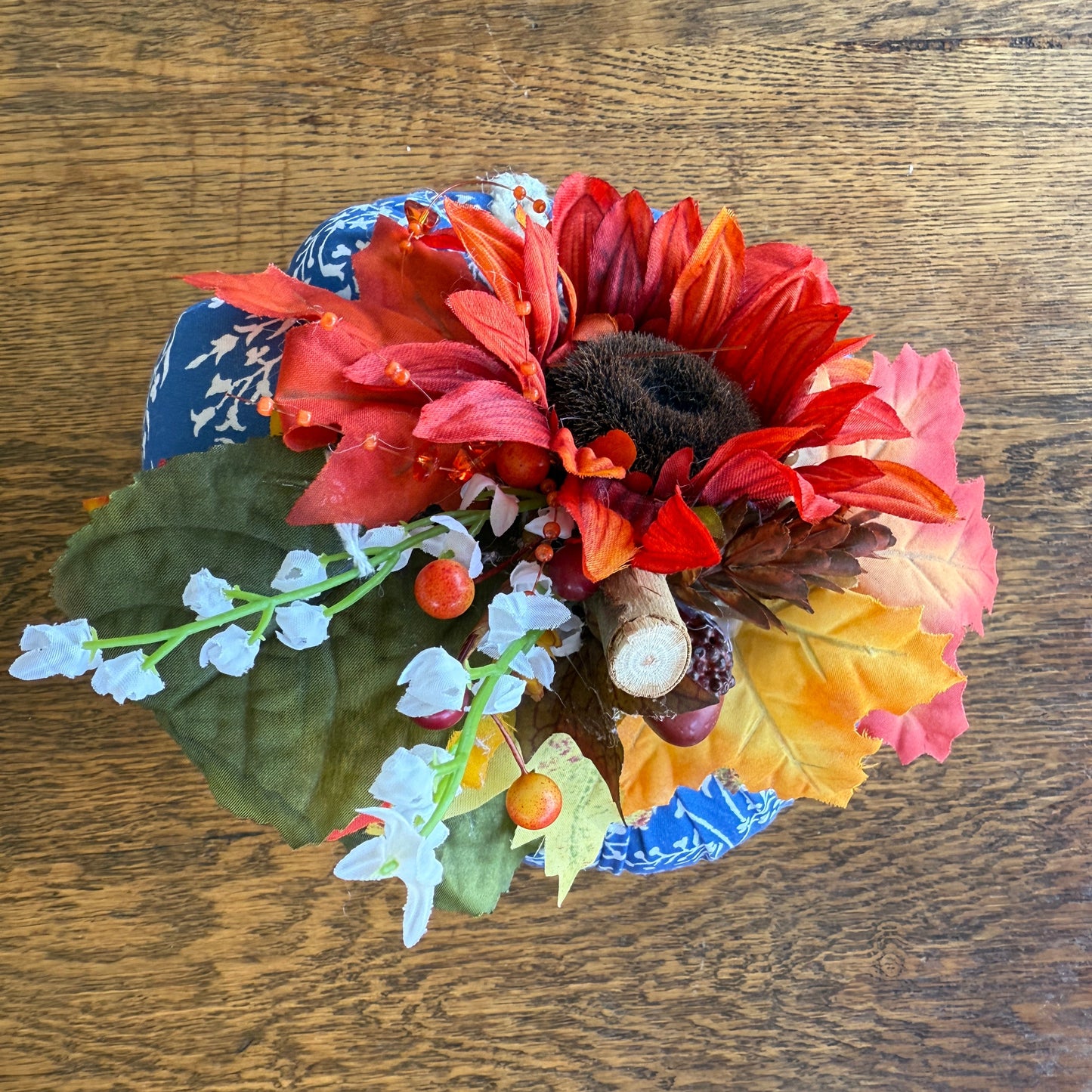 Colorful flower arrangement in a blue and white bowl on a wooden surface