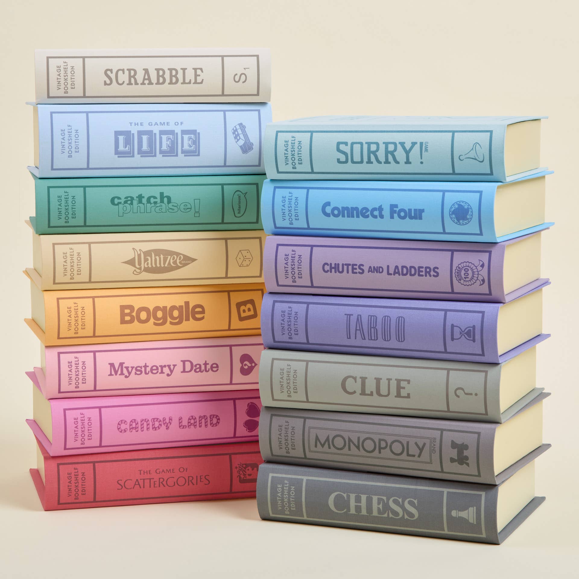 Stack of colorful board game boxes on a beige background