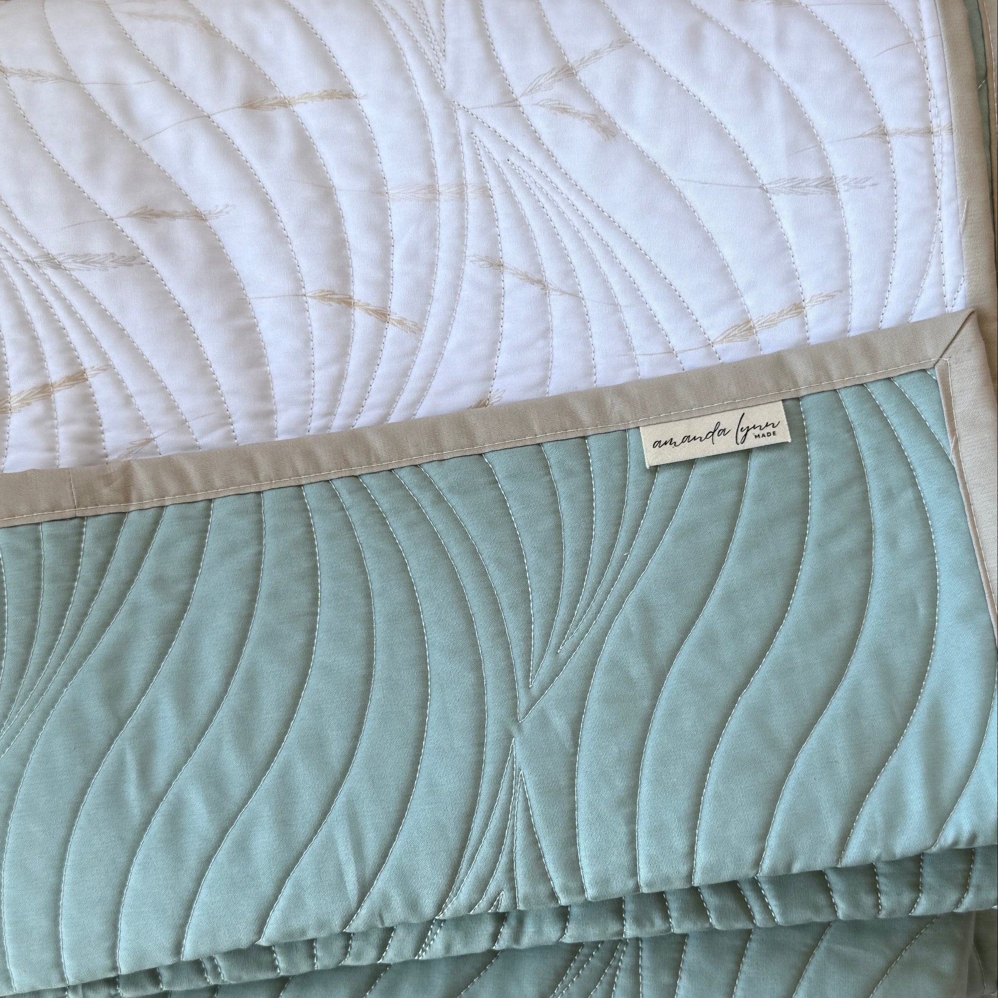 Quilted fabric with a brand label on a white background