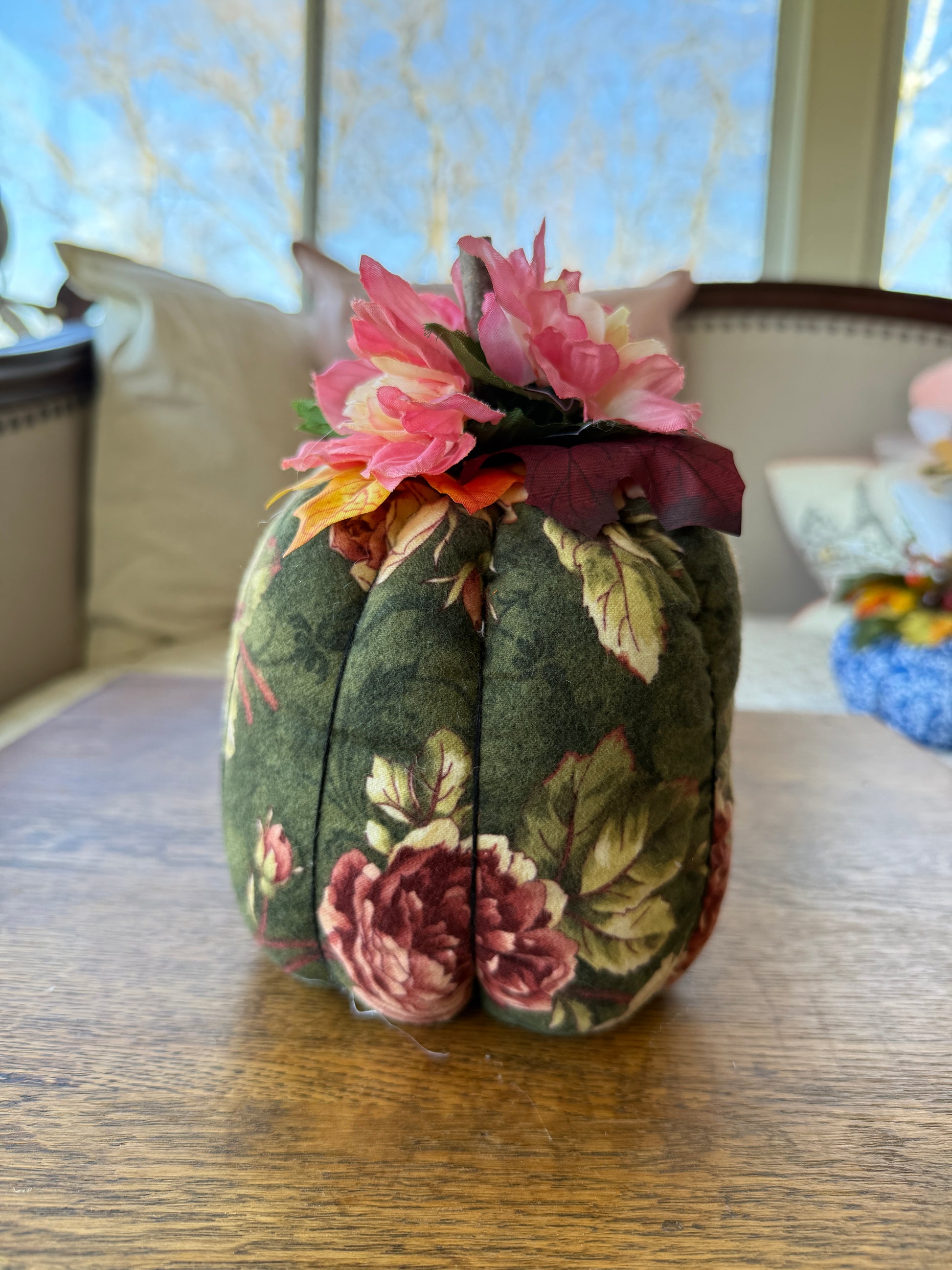 Floral-patterned headband with pink flowers on a wooden surface