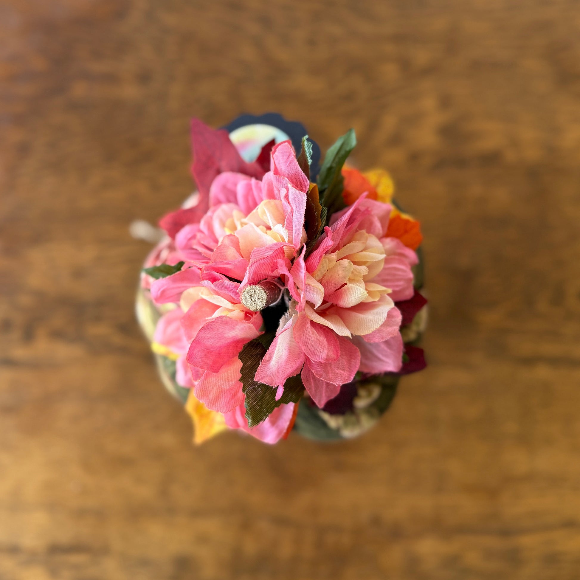 Small bouquet of pink flowers on a wooden surface