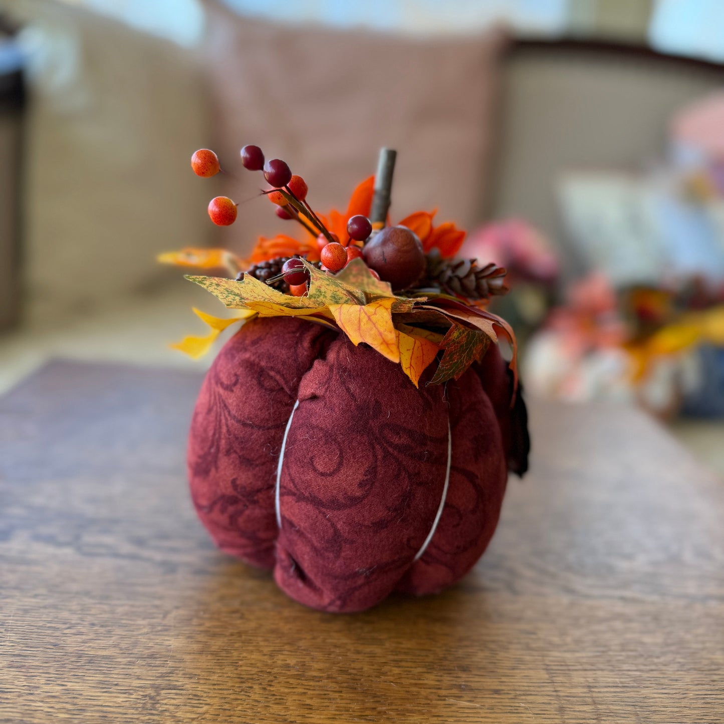 Decorative pumpkin with autumn elements on a wooden surface