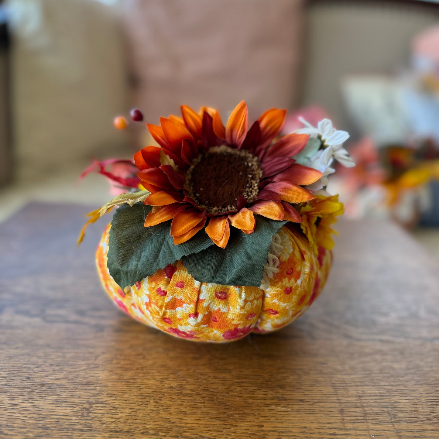 Decorative pumpkin with sunflower on a wooden table