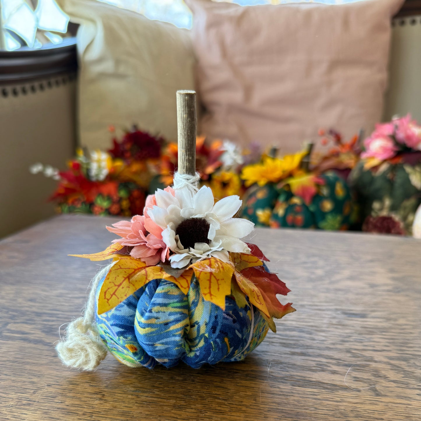 Decorative wreath with flowers and leaves on a wooden surface