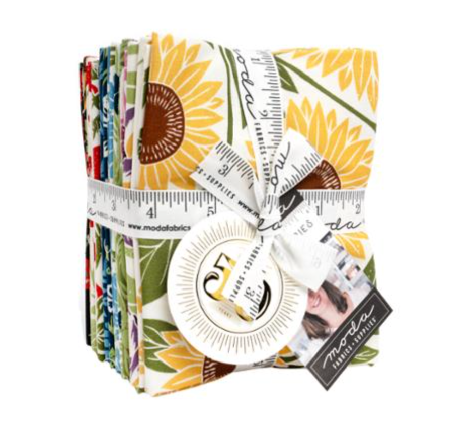Pack of fabric squares with sunflower pattern and Moda label on a white background